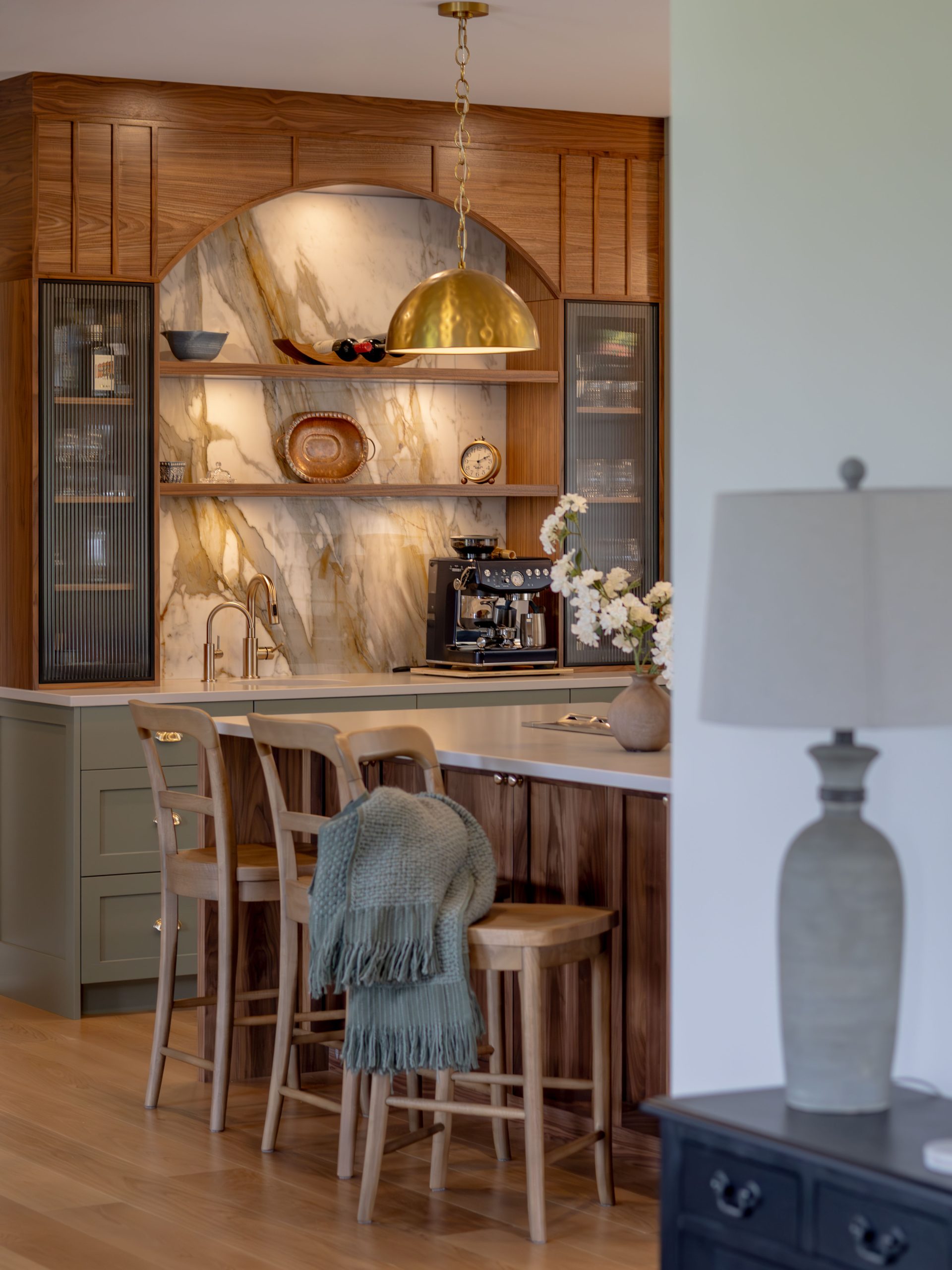 Architectural walnut arch softening lines and adding bespoke character to the kitchen interior.